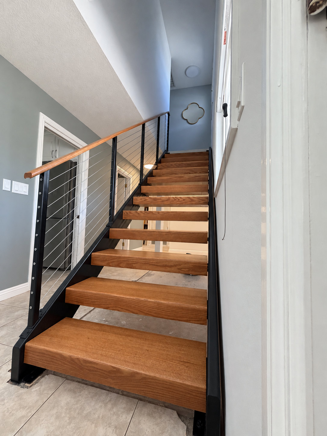Floating wood stairs with cable railing